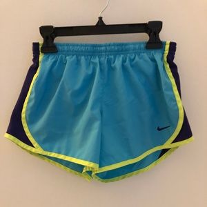 blue, yellow, and purple nike tempo shorts